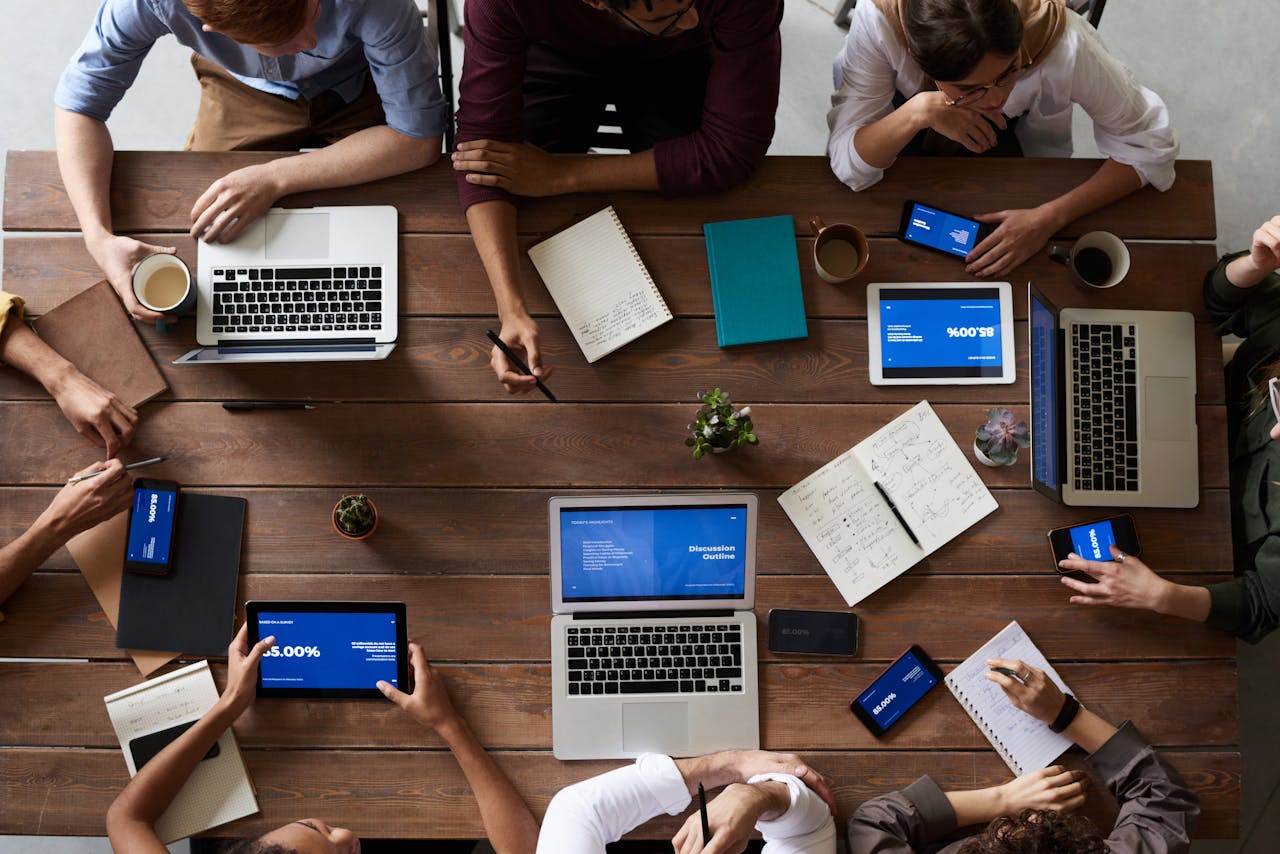 A marketing team with devices sitting at a table