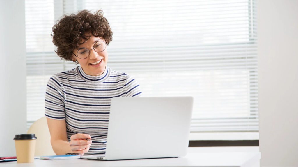 Person reviewing and editing a digital document on a laptop